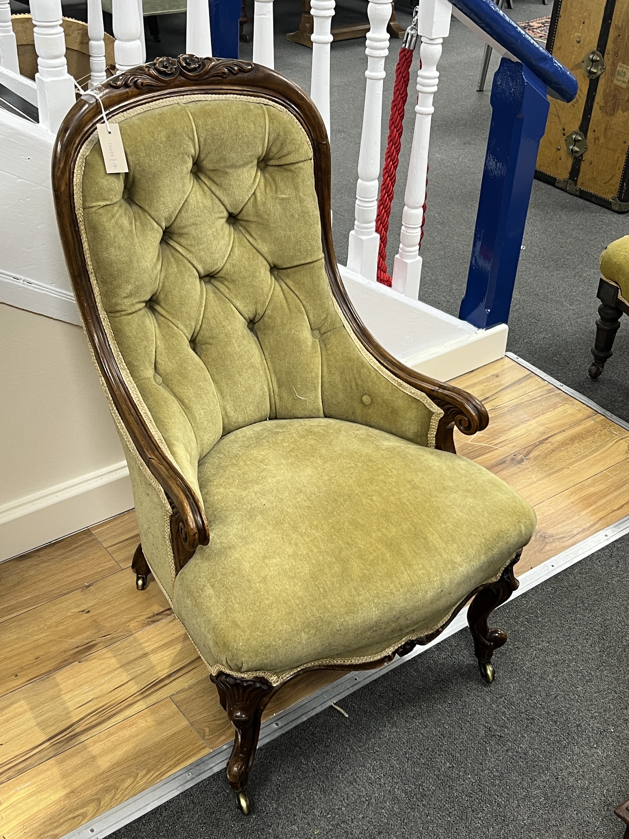 A Victorian carved walnut spoon back armchair, width 52cm, depth 66cm, height 91cm